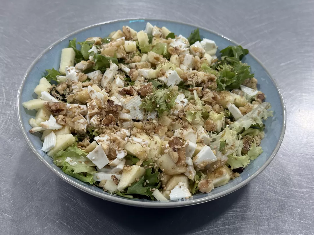 Ensalada verde con manzana, sésamo, nueces y queso de cabra.